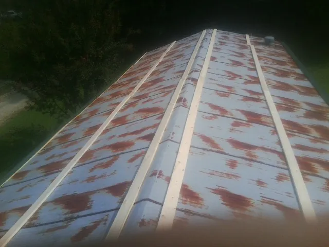 Rusted metal roof panels with new wood purlins before replacement — Storm Damage Roof Repair in Haverford by Roofing Brothers